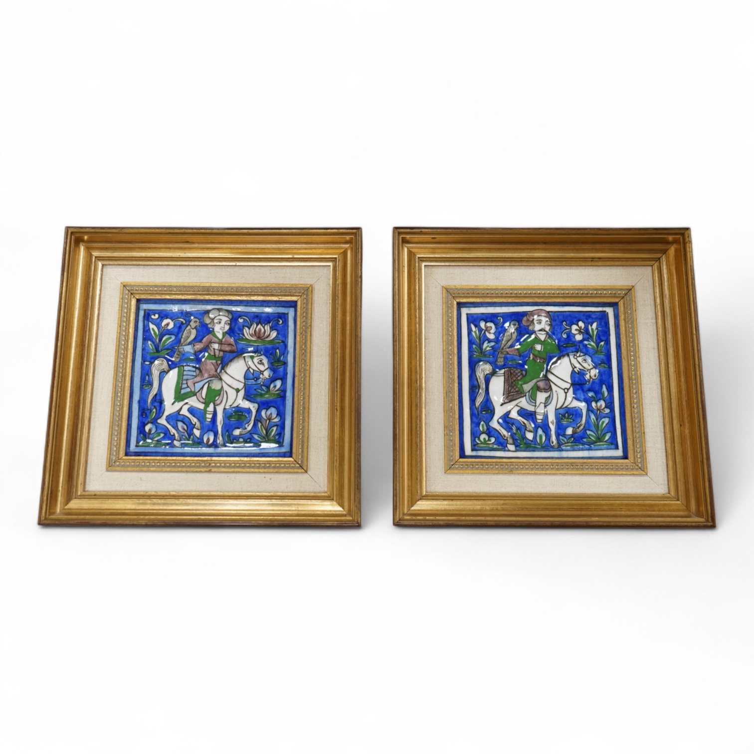 A pair of 19th century Persian fritware tiles depicting falconers, framed, 14cm squared